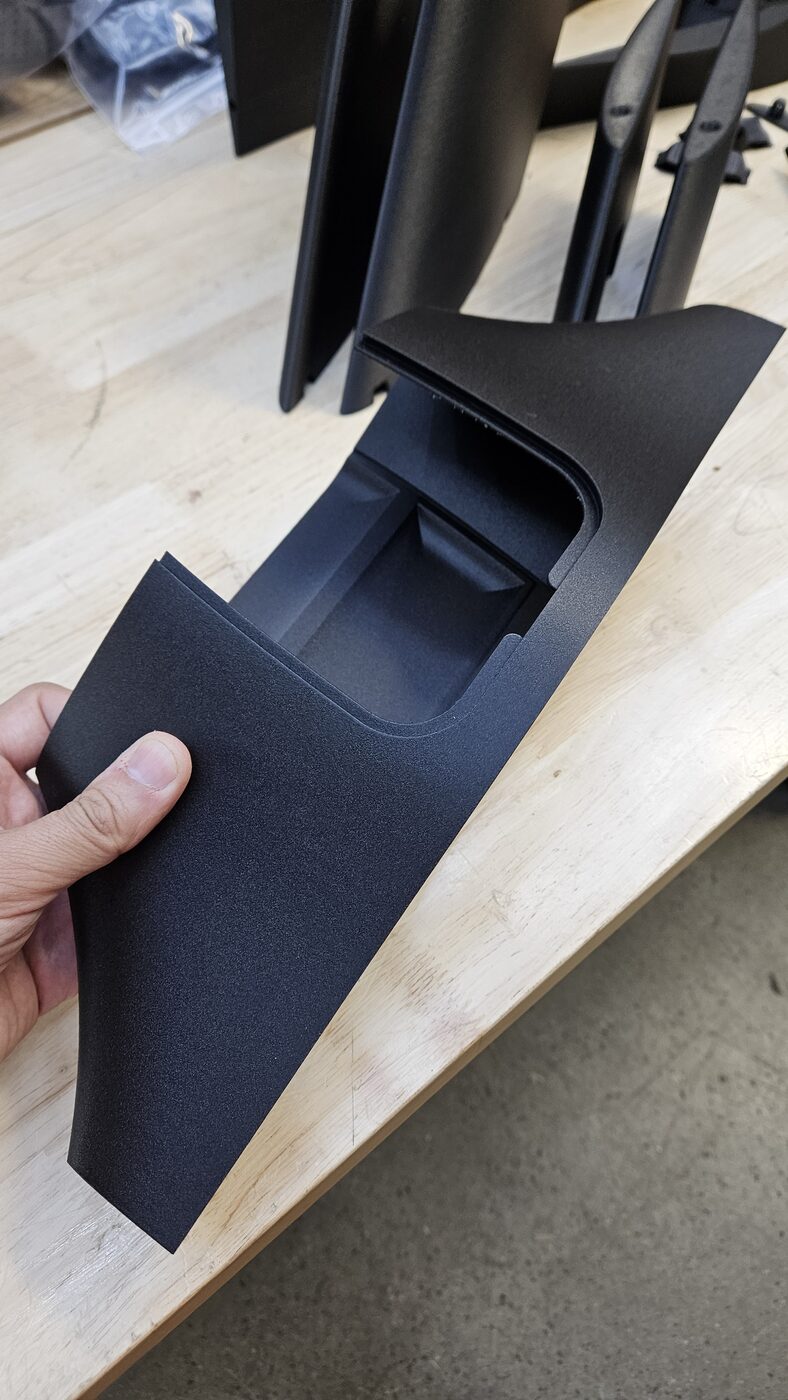 Close-up of a finished 3D printed drone part being inspected by hand